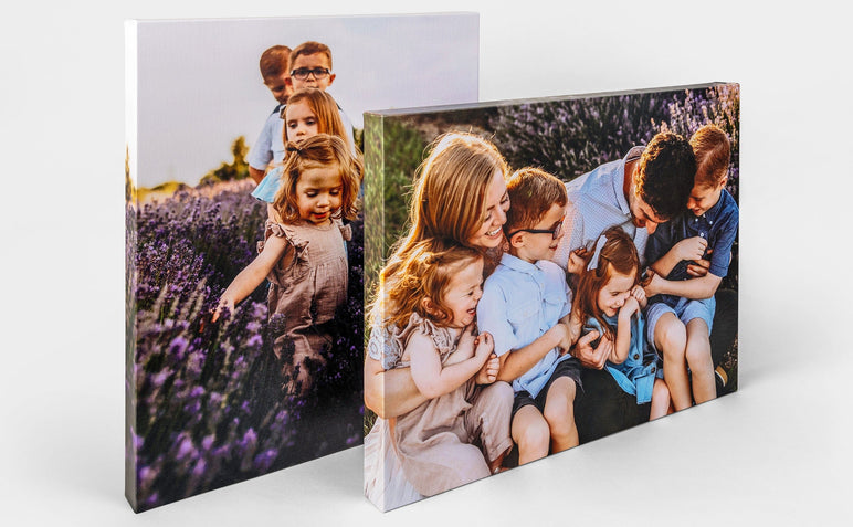 Two Premium Canvas Prints on a white background featuring a family having fun outdoors. The Canvases are shot from the side.