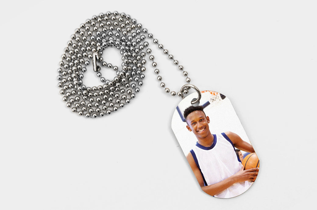 One Dog Tag featuring a picture of a teen basketball player. 