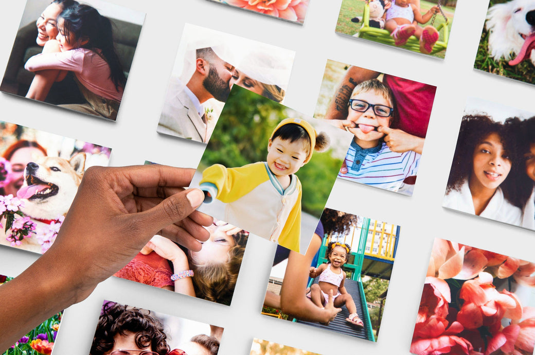 Flat lay of 4x4" Professional Photo Prints featuring pictures of kids, couples, flowers, and dogs. 