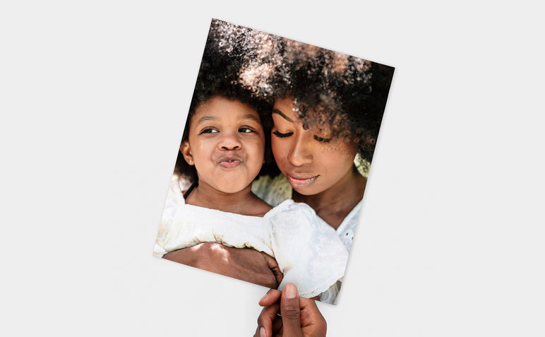 Flat lay of a 8.5x11" Professional Photo Prints featuring a picture of a mother and her daughter. 