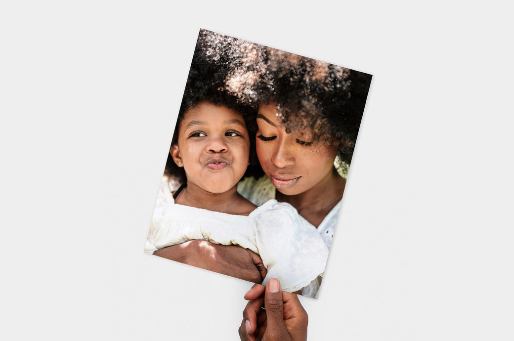 Flat lay of a 8.5x11" Professional Photo Prints featuring a picture of a mother and her daughter. 