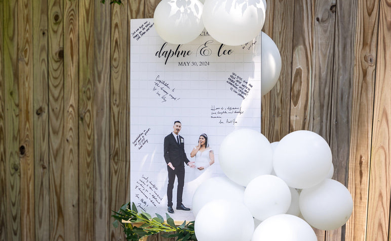 Wedding themed Signing Board mounted on 3/16" Gatorboard in front of a fence outdoors. 