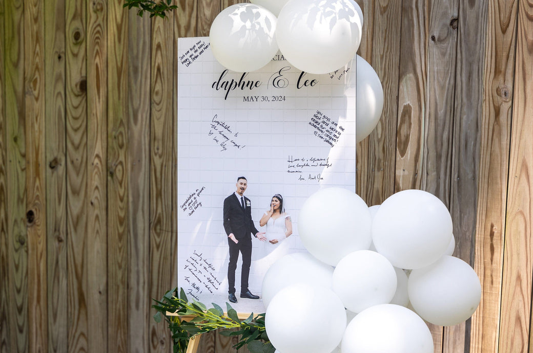 Wedding themed Signing Board mounted on 3/16" Gatorboard in front of a fence outdoors. 