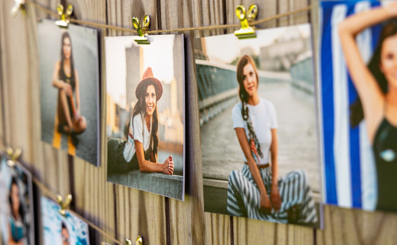 Set of 5x5" Photo Prints mounted on Single Weight Matboard and strung along a fence with twine and bullclips. Prints feature photos of a Grad.