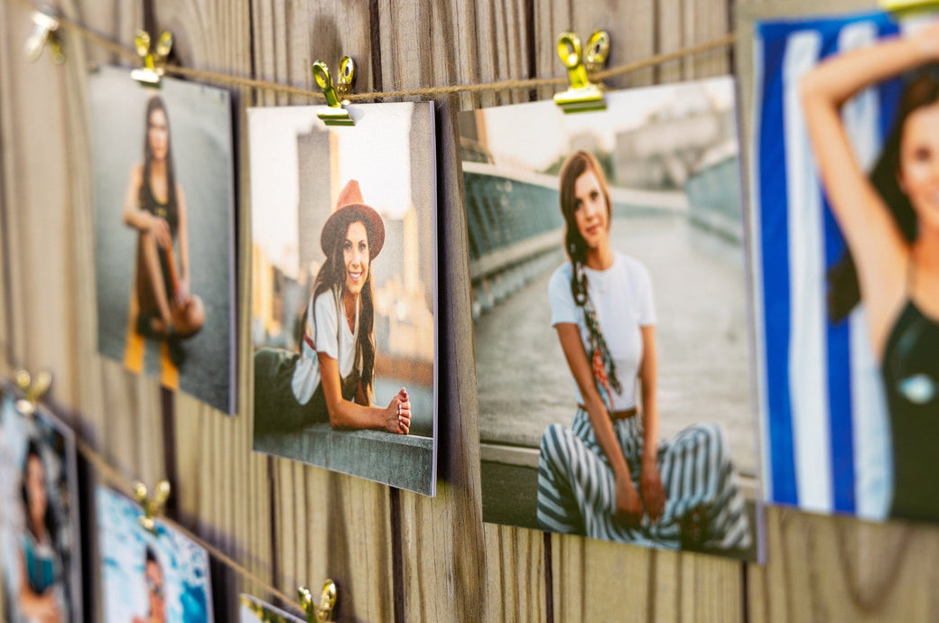 Set of 5x5" Photo Prints mounted on Single Weight Matboard and strung along a fence with twine and bullclips. Prints feature photos of a Grad.