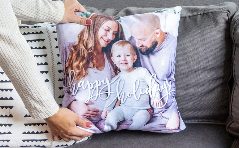 Woman placing a Holiday Photo Pillow on a couch.