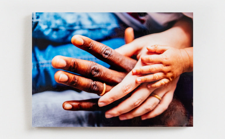 Single Glossy Photo Print featuring a photo of three hands; a man, woman and baby's.