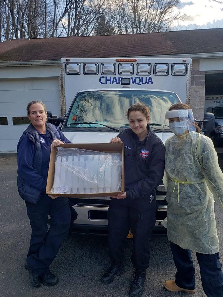 medical staff with boxes of masks