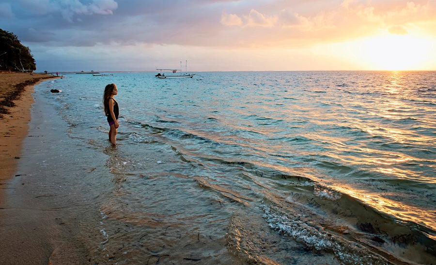shoreline with child in ocean
