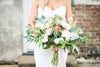 Bridal portrait with floral bouquet by The Reason Photography