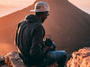 Photographer sits atop a rock