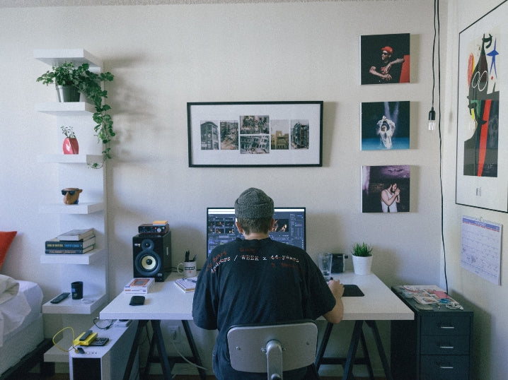 A photographer works at his desk