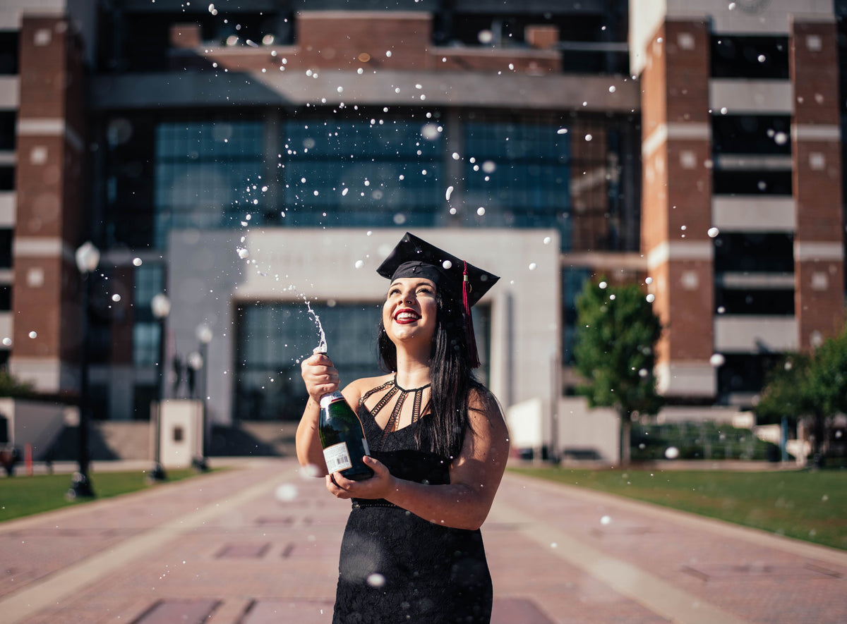 Grad popping champagne
