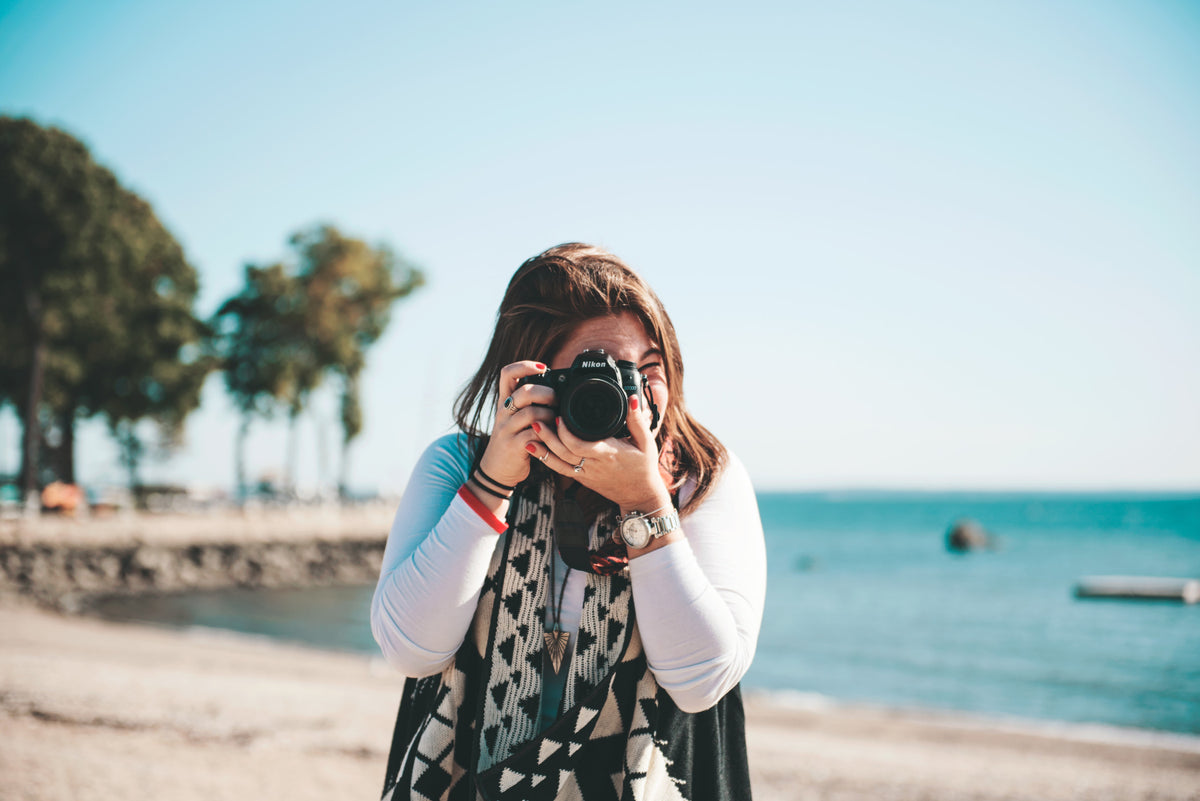 Girl taking picture with DSLR Camera