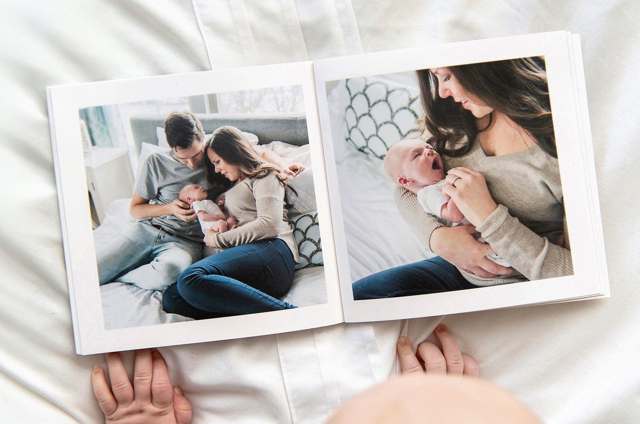 An open Buzz Book featuring photos of a man and woman and their new baby.