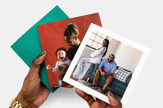 Three Buzz Books with different covers being held by a woman. The top cover features a maternity photo of a man and a pregnant woman.