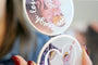 Compact Mirrors with pictures of a family and a young child. 