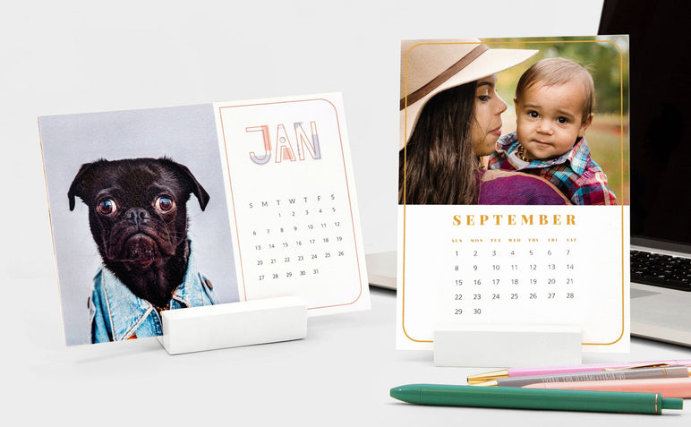 Two Desk Calendars: one landscape Desk Calendar with a picture of a dog and one portrait Desk Calendar with a woman and a baby.