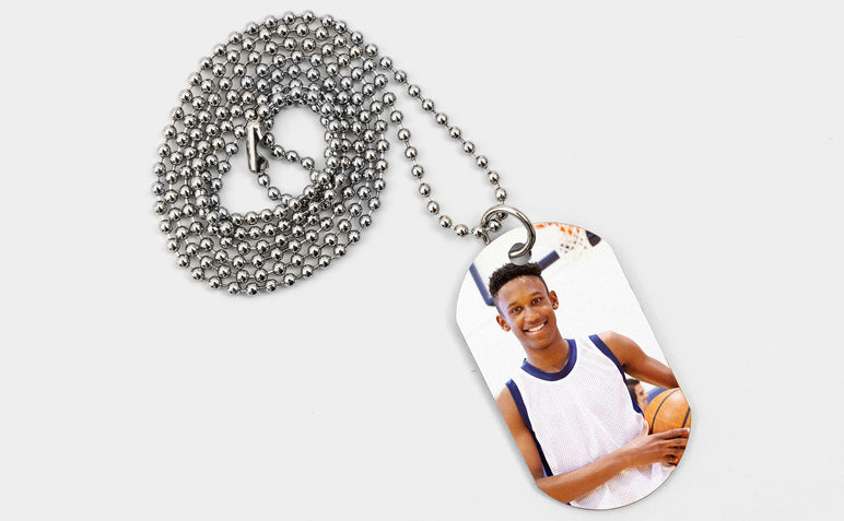 One Dog Tag featuring a picture of a teen basketball player. 