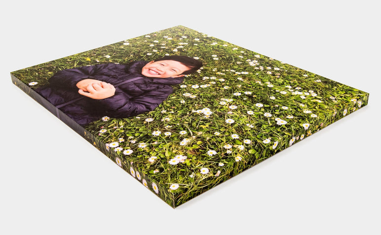 Angled shot of a 16x20" Gallery Block featuring a photo of a child on a field of flowers.