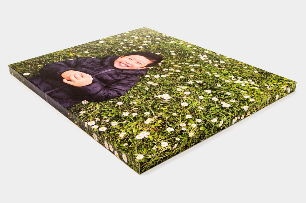 Angled shot of a 16x20" Gallery Block featuring a photo of a child on a field of flowers.
