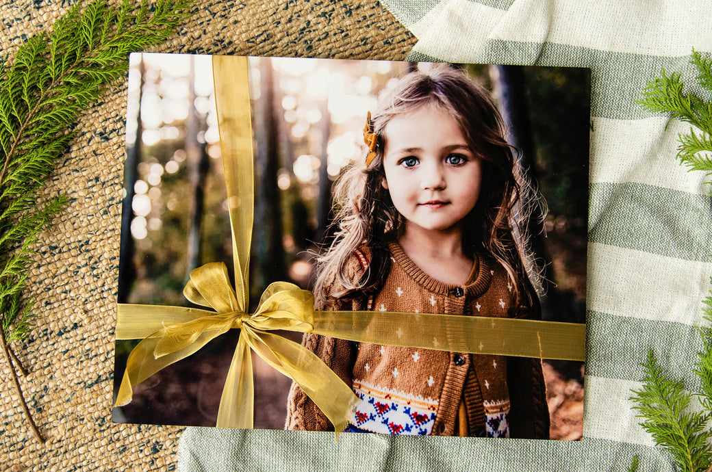 16x20" Metal Print wrapped with a ribbon featuring a wintery photo of a little girl.