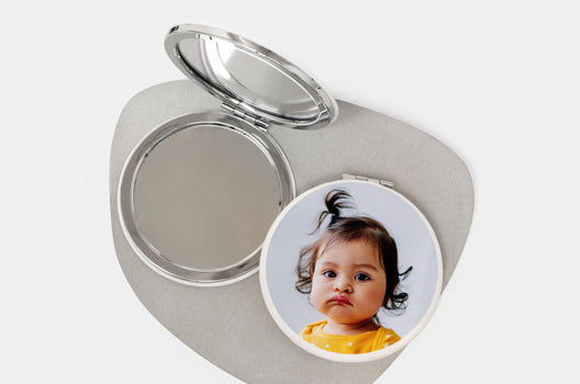 Two Compact Mirrors, one open and the other with a photo of a small child on the cover - Nations Photo Lab