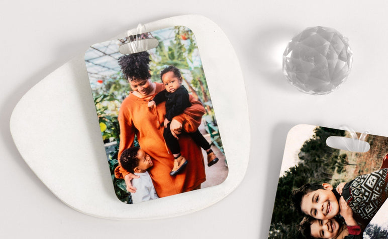 Flat lay of two Luggage Tags featuring photos of children and a Mother with her kids. 