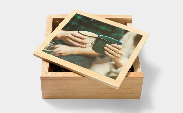 Two people clinking camp mugs on the cover of a custom Wooden USB Box