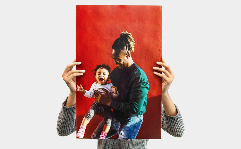 Woman holding a 14x22" Photo Print featuring a picture of a dad and his daughter 