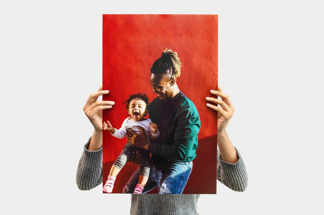 Woman holding a 14x22" Photo Print featuring a picture of a dad and his daughter 