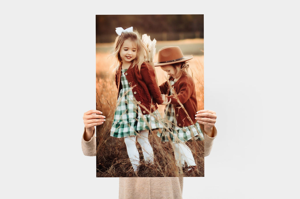 Woman holding a 20x30" Photo Print featuring a picture of two children. 