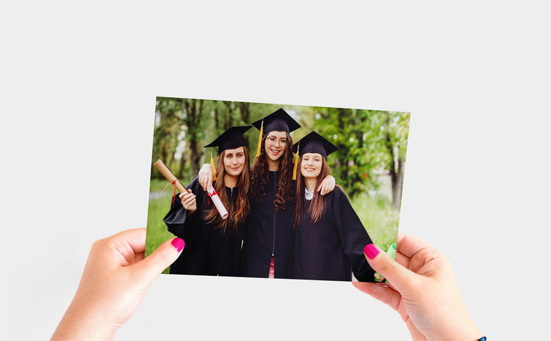 Flat lay of a 7x10" Professional Photo Prints featuring a picture of three recent graduates