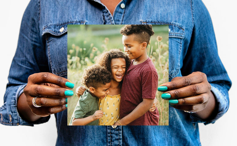 Flat lay of a 8x8" Professional Photo Prints featuring a picture of three children
