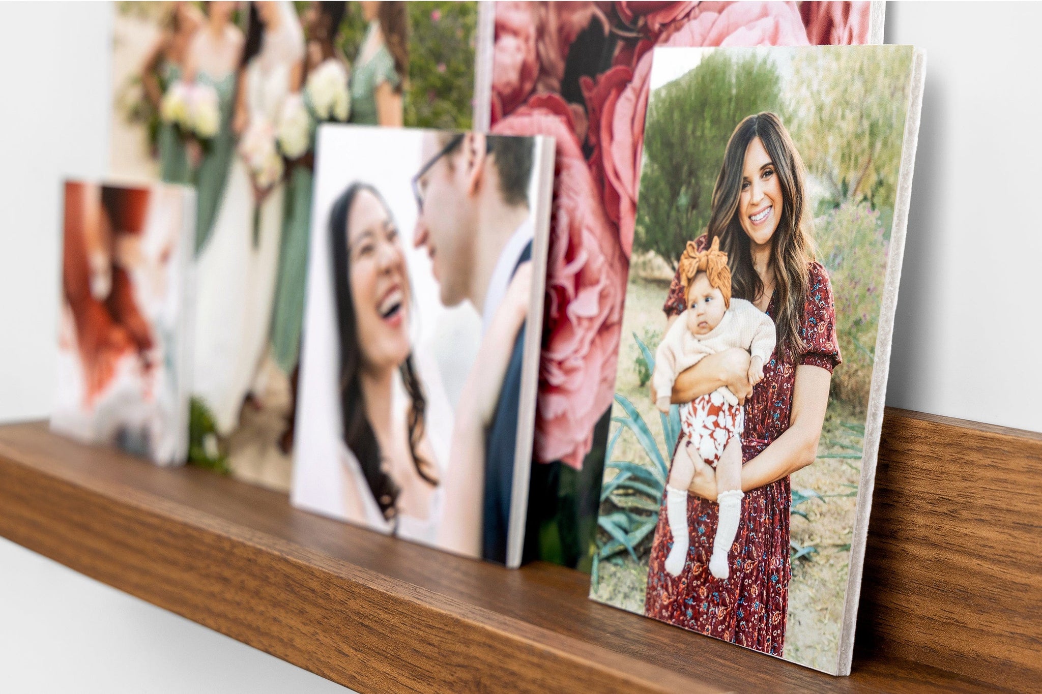 Five photo prints mounted on Foamcore styled on a photo ledge. The focus image is 4x6" and features a mother and her baby son.