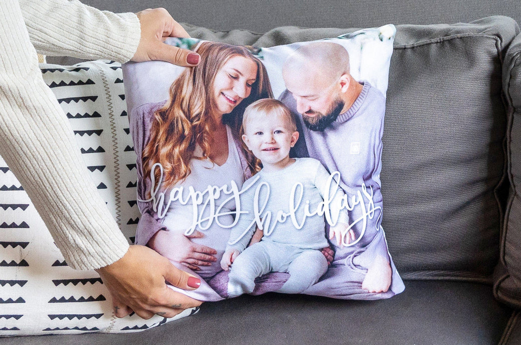 Woman placing a Holiday Photo Pillow on a couch.
