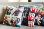 Three Holiday Photo Pillows on a gray couch. 