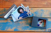 Both Classic and Standard Wallet Boxes on a wood table, with Wallet Prints inside on them - Nations Photo Lab