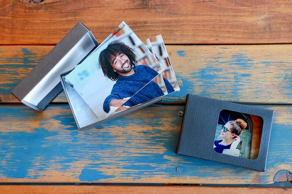 Both Classic and Standard Wallet Boxes on a wood table, with Wallet Prints inside on them - Nations Photo Lab