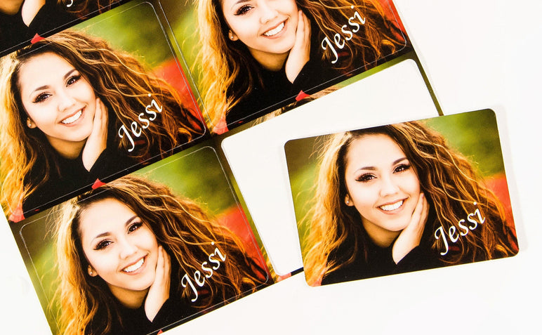 Picture of 8 Die Cut Signature Wallets with a photo of a teen girl on them and the script text "Jessi" in the bottom right corner.