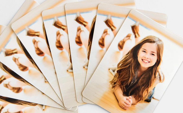 Stack of 8 Die Cut Wallet Photo Prints with a picture of a young girl on them.