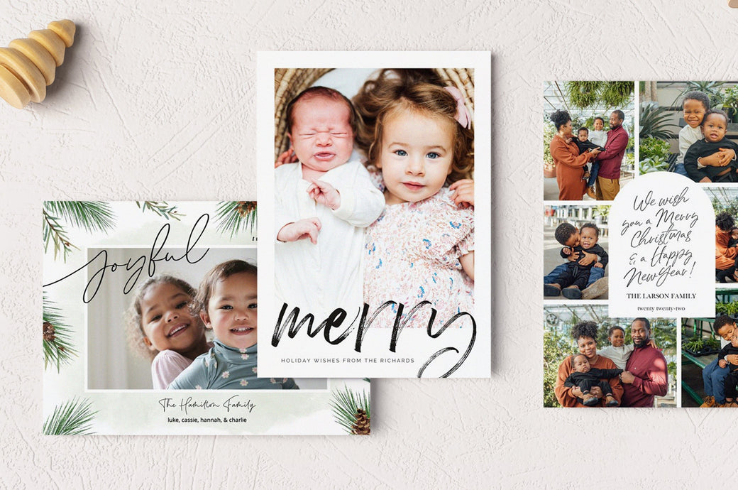Flat lay of three 5x7" Photo Paper Holiday Cards: Joyful Pines, Brushstroke Wishes, and Merry Message.