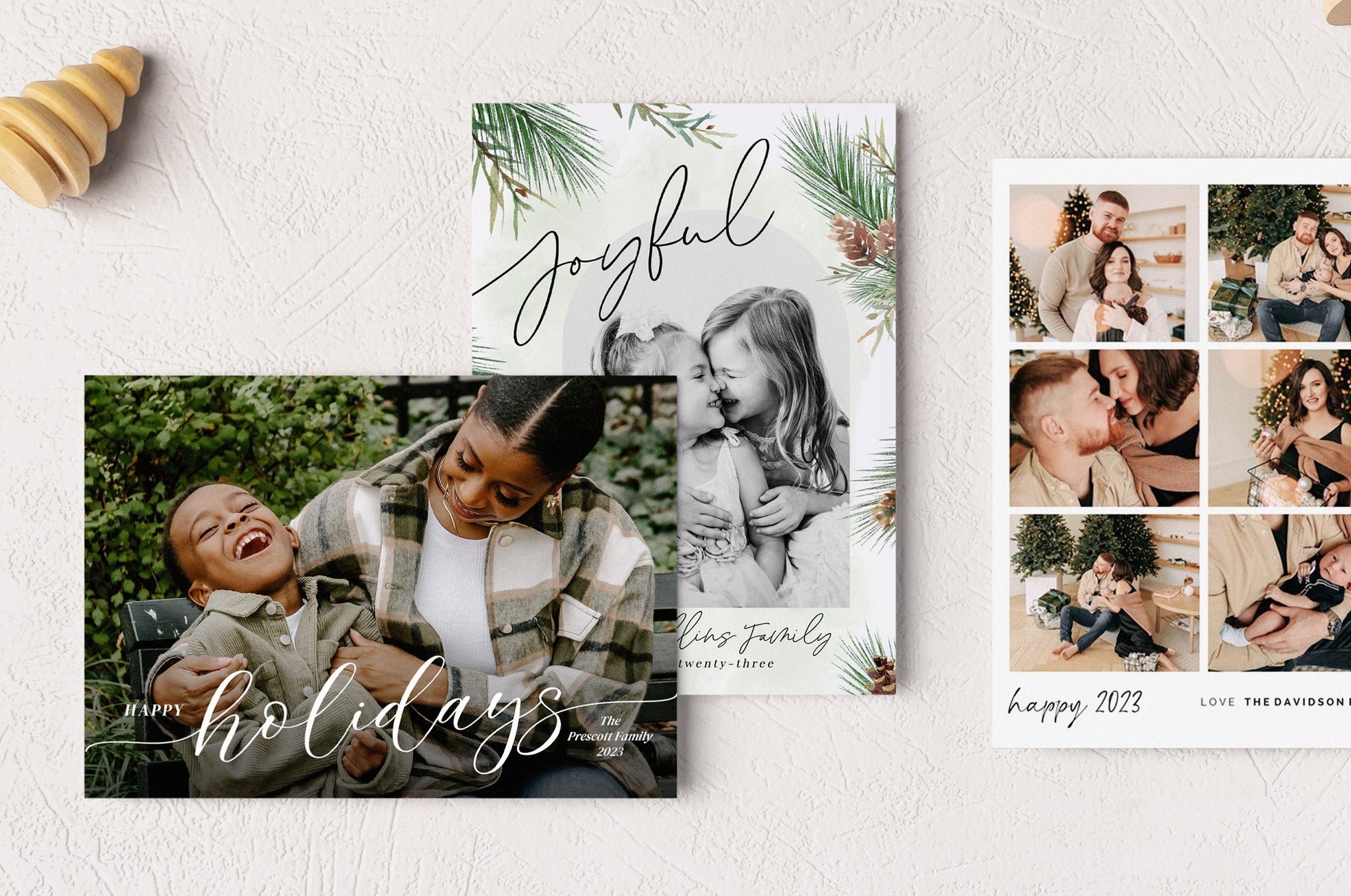 Flat lay of three 5x7" Photo Paper Holiday Cards: Classic Holiday, Joyful Pines, and Happy Collage.