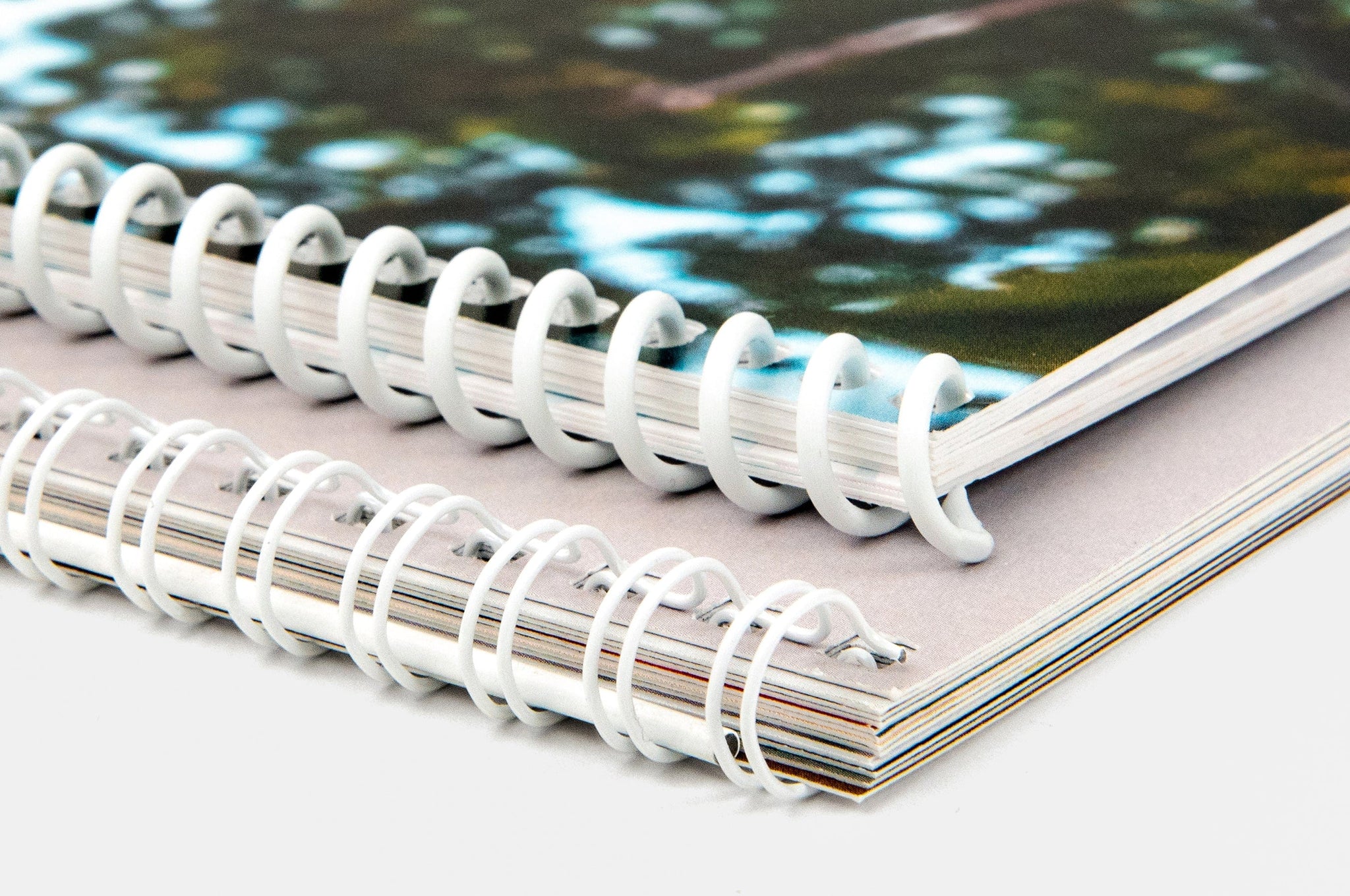 Close up detail shot of the wire binding for both a 8.5x11" Wall Calendar and a 11x17" Wall Calendar