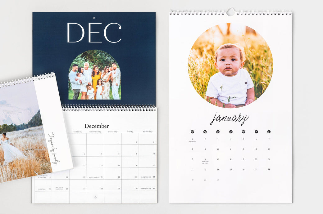 Flat lay of two 8.5x11" Wall Calendars, one open and one closed, as well as an open 11x17" Wall Calendar.