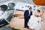 alt= The bride hugging her father on black and white print next to a 30x40 photo of the married couple on the beach  
