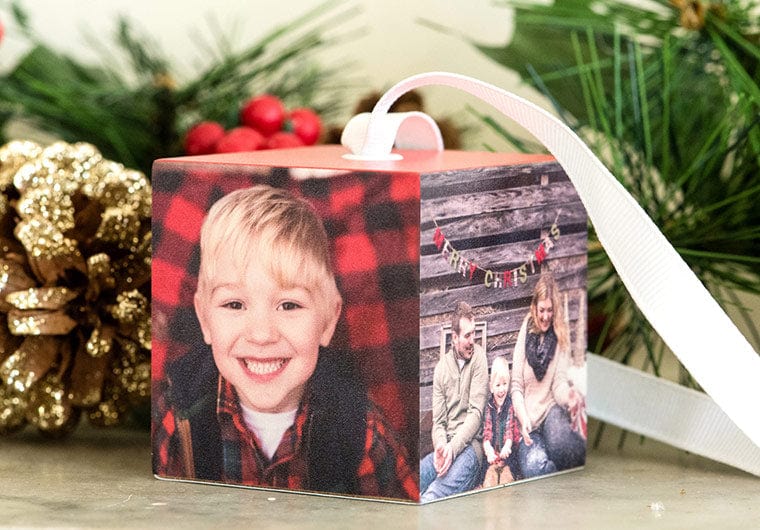Family of three posing for pictures on a Custom Cube Ornament
