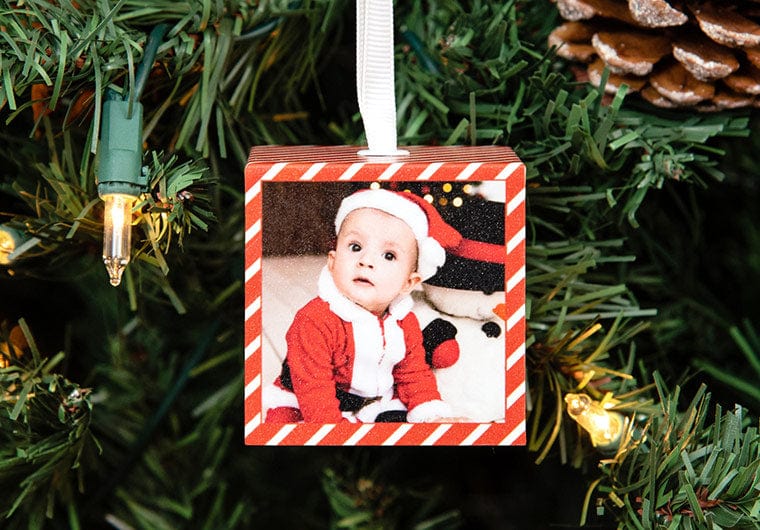 Baby boy dressed in a Santa Costume on a Custom Cube Ornament hanging on a Christmas Tree