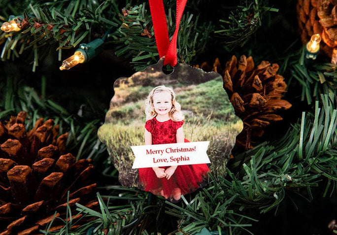 Little girl named Sophia on a Custom Metal Ornament hanging on a Christmas Tree