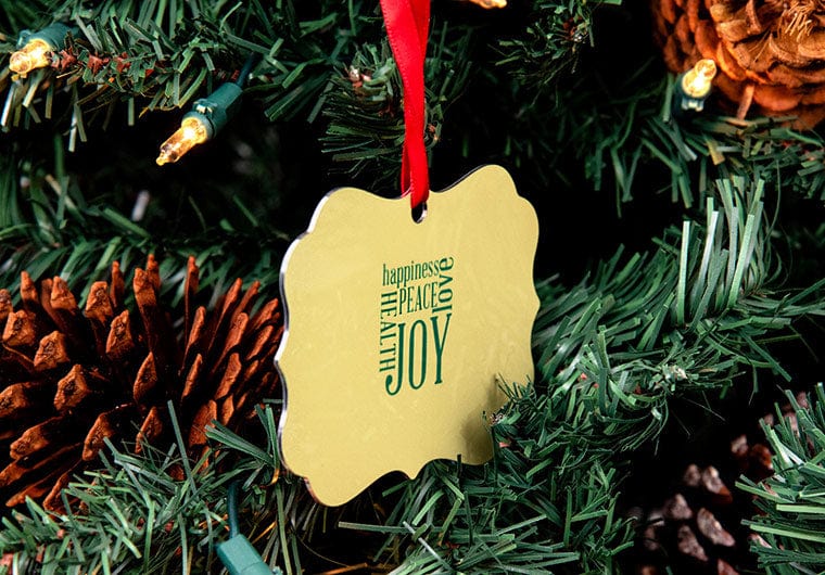 The back of a Custom Metal Ornament hanging on a Christmas Tree